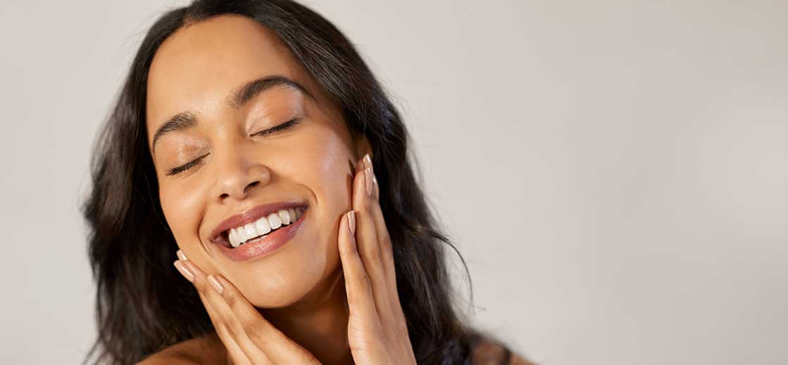 Woman with glowing, healthy skin, showcasing the benefits of professional skincare products in Orange, CA.