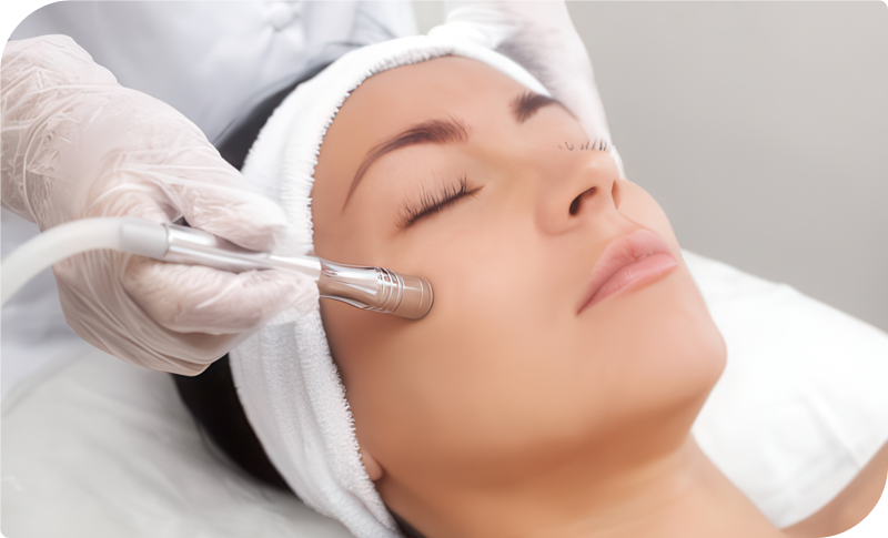 Woman receiving a microdermabrasion treatment to exfoliate and rejuvenate her skin at Facials & Skincare by Debbie in Orange, CA.