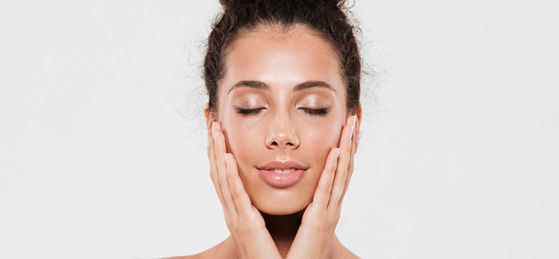 Relaxed woman after a facial treatment, showing glowing, refreshed skin. Serving clients in Orange County, including Anaheim, Santa Ana, and Tustin.